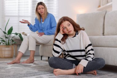 Ergen kız, evde annesini görmezden geliyor, seçici odaklanıyor.