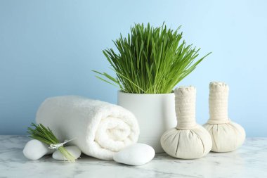 Spa composition with wheatgrass on white marble table