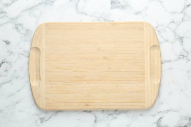 Beyaz mermer masa üzerinde bir tahta kesim tahtası, üst manzara.