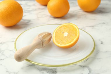 Taze portakalın yarısı ve beyaz mermer masa, yakın plan.