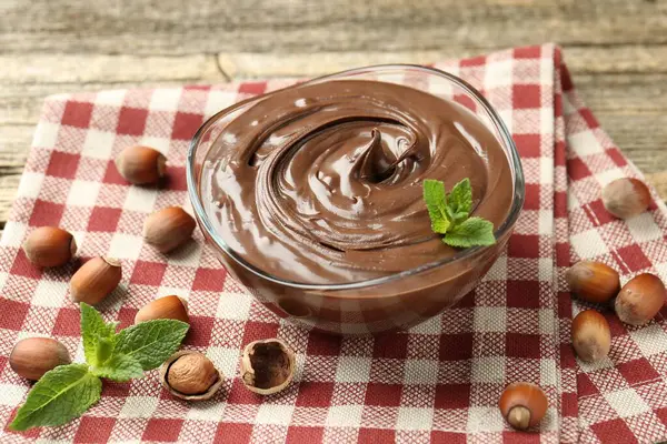 Nefis çikolata, naneli ve fındıklı ahşap masa, yakın plan.