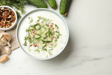 Beyaz mermer masadaki ürünlerin arasında salatalık çorbası, dereotlu fındıklı ve fındıklı. Metin için boşluk