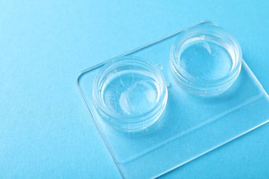 Açık mavi arkaplanda kontak lensler, yakın plan