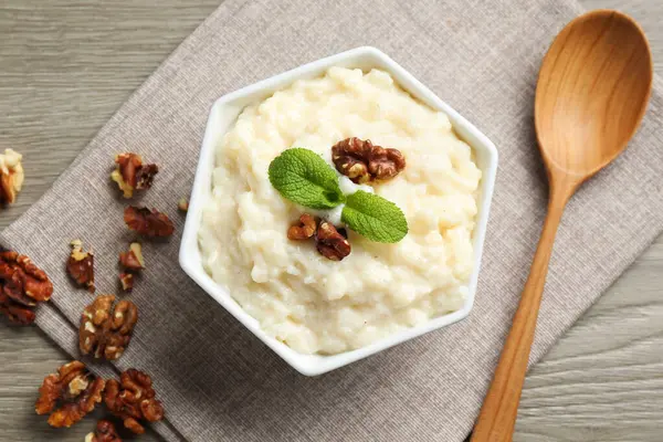 Cevizli, nane ve kaşıklı lezzetli sütlaç ahşap masada, düz yatıyordu.