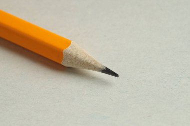 Hafif arka planda keskin bir grafit kalem, yakın plan. Metin için boşluk