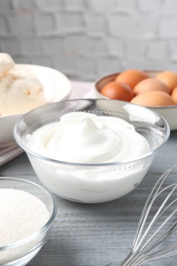 Krem şanti, şeker, yumurta ve çırpılmış çırpılmış çırpılmış çırpılmış gri ahşap masa, yakın plan. Kurabiye pişiriyorum.