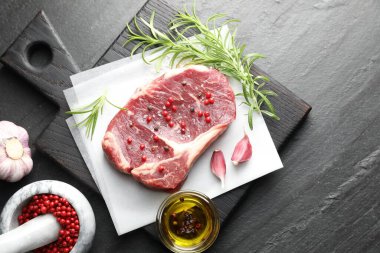 Siyah masada çiğ et ve baharat var.