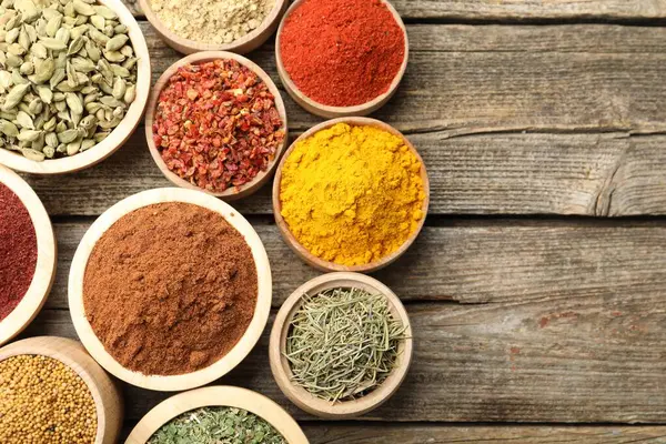 Tahta masada, düz bir zeminde farklı aromatik baharatlar var. Metin için boşluk