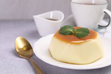 Karamel soslu lezzetli puding ve nane şekeri, yakın plan.