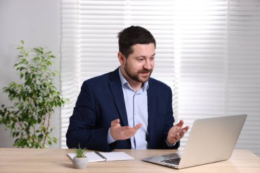 İçerideki masada dizüstü bilgisayarı olan internet hoparlörü.