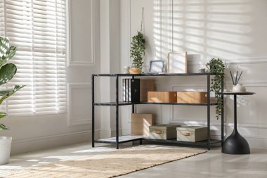 Beyaz duvarın yanında farklı dekorları olan konsol masası. İç tasarım