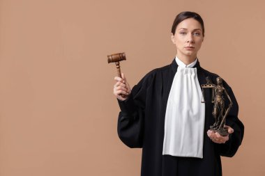 Açık kahverengi arka planda Adalet Anıtı 'nın çekiciyle ve figürüyle yargıla.