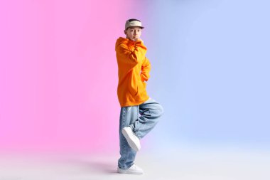 Renkli arka planda dans eden şık elbiseli çocuk.