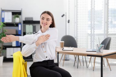 Ofiste sandalyede uzanan güzel bir kadın.