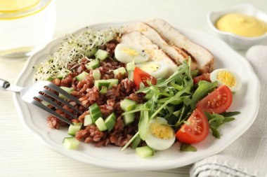 Beyaz ahşap masada kahverengi pirinçli leziz salata, yakın plan.