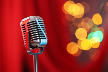 Kırmızı perdeye karşı bir klasik mikrofon, mesaj için yer. Bokeh etkisi