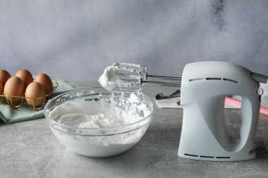 El çırpıcı ve krem şanti gri desenli masada, yakın plan.