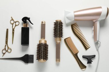 Beyaz arka planda farklı saç şekillendirme araçları, düz yatış