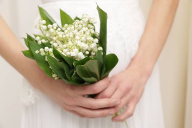 İçinde güzel vadi zambakları olan gelin, yakın plan.