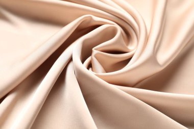 Arkaplan olarak bej buruşuk ipek kumaş, yakın plan