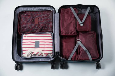 Beyaz arkaplanda paketleme küpleri olan bavulu aç, üst görünüm