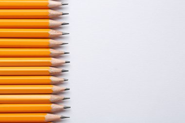 Hafif arka planda keskin grafit kalemler, düz yatış. Metin için boşluk