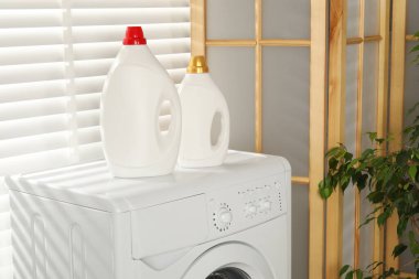 Çamaşır makinesinde yumuşatıcı şişeler.