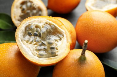 Olgun çarkıfelek meyveleri ve yeşil yapraklar masada, yakın çekim