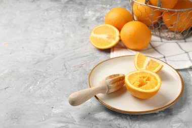 Tahta sıkacağı ve gri masada taze portakallar. Metin için boşluk