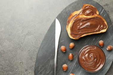 Lezzetli çikolatalı tostlar ve gri desenli masada fındıklar, üst manzara. Metin için boşluk