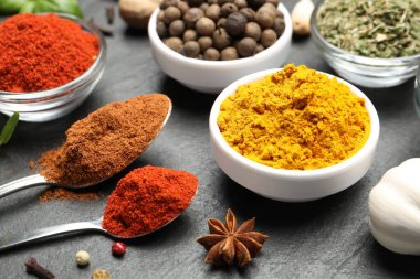 Siyah masada farklı aromatik baharatlar, yakın plan.