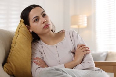 Evdeki kanepede depresif bir kadın, mesaj atmak için yer var.