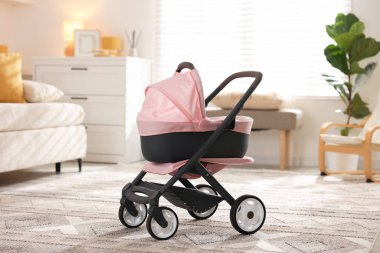 Bebek arabası oturma odasında duruyor. Çocuk oyuncağı.