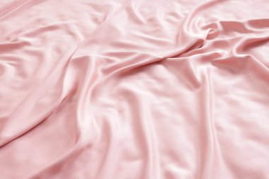 Yatakta güzel pembe ipek çarşaflar, yakın plan