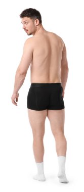 Beyaz arka planda siyah iç çamaşırlı genç adam.