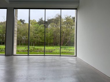 Panoramik pencereli ve gri zeminli boş oda