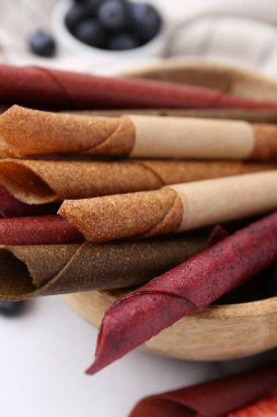 Lezzetli meyve dürümleri ve beyaz masada böğürtlenler, yakın plan.