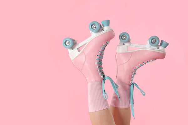 Woman in roller skates on pink background, closeup. Space for text