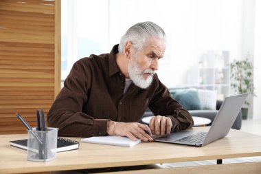 Üst düzey adam içeride masa başında öğrenirken not alıyor. Kendi kendine çalışma.