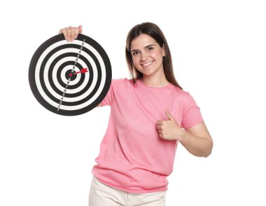 Hedef alınıyor. Dart tahtası ve okla gülümseyen kadın beyaz arka planda baş parmağını gösteriyor.