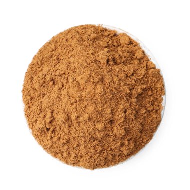 Süper yemek. Kasedeki tarçın tozu beyaza izole edilmiş, üst manzara