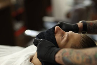 Berber dükkanında müşteriyle çalışan profesyonel berber, yakın plan. Metin için boşluk