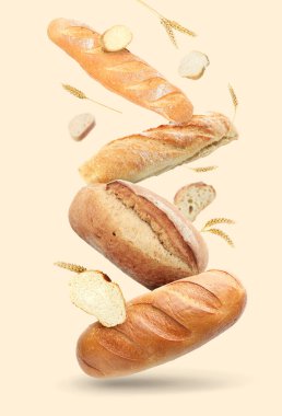Bej arkaplana düşen farklı ekmek ve dikenler.