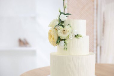 Çiçeklerle süslenmiş nefis düğün pastası, yakın plan.