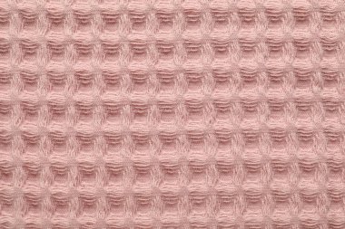 Arka plan olarak temiz pembe waffle havlusu, üst görünüm