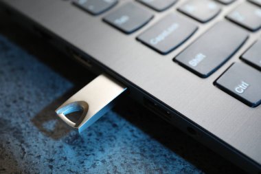 USB flaş bellek koyu gri masadaki dizüstü bilgisayara bağlandı.