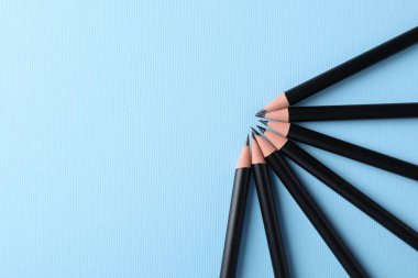 Açık mavi arka planda bir sürü keskin grafit kalem, düz yatıyordu. Metin için boşluk