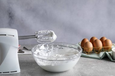 El çırpıcı ve krem şanti gri desenli masada, yakın plan.