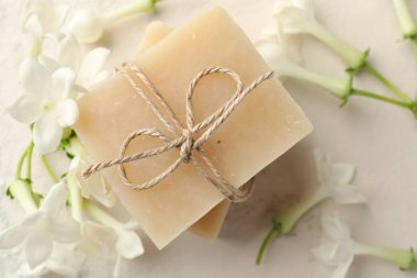 Sabun ve yasemin çiçekleri ışık masasında, düz yatıyordu.