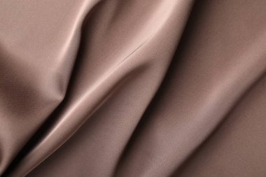 Arkaplan olarak buruşuk açık kahverengi ipek kumaş, üst görünüm